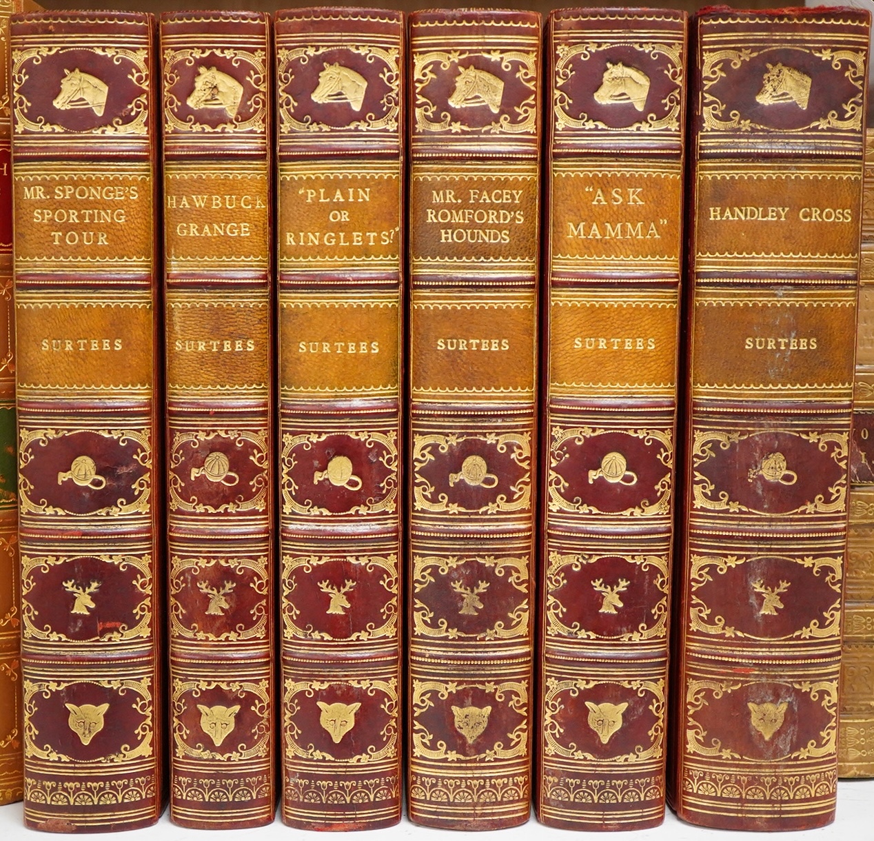 [Surtees, John - Sporting Novels], subscriber's edition, 6 vols. coloured title vignettes and num. hand coloured plates (by John Leech & H.K. Browne); contemp. gilt pictorial, decorated and ruled red calf, panelled spine